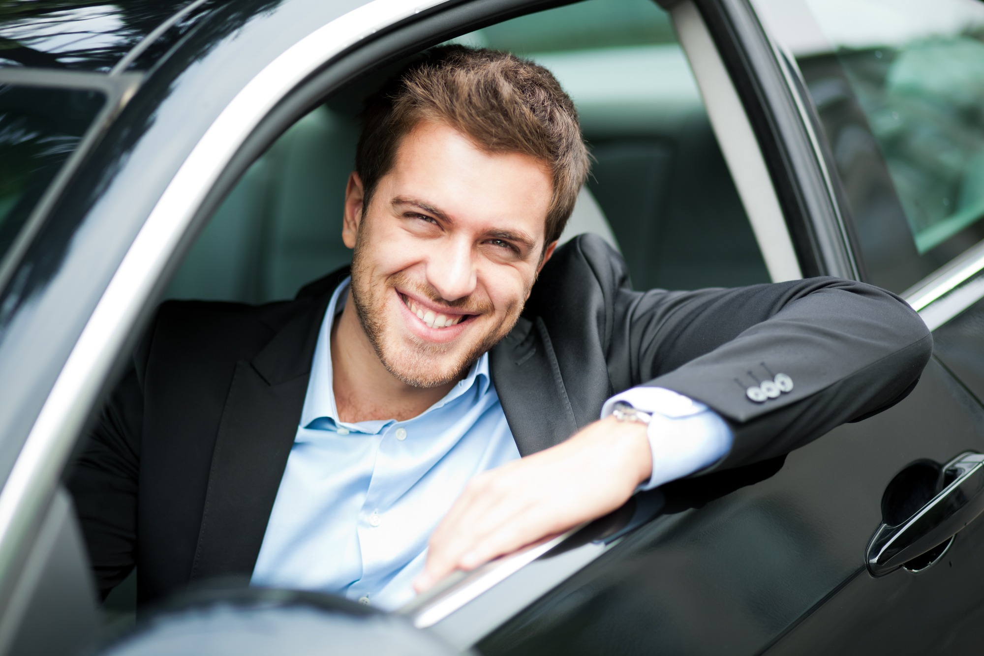 Young man sitting in a car